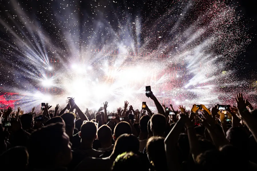 excited-audience-watching-confetti-fireworks-having-fun-music-festival-night-